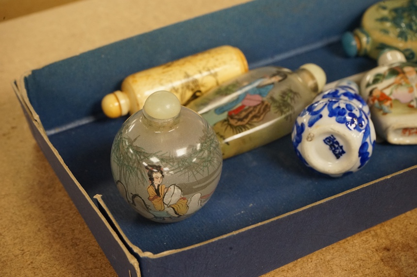 A group of Chinese snuff bottles to include porcelain, bone, enamelled, glass and amber examples, tallest 8cm. Condition - varies